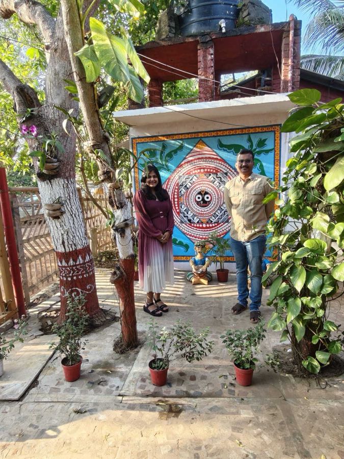 Meghna and Amarnath before a Jagannath pattachitra mural